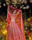 Sitara coral red silk bridal lehenga, back view, Amaltas Couture