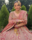 Gulrang pink tissue bridal lehenga seated, embroidered blouse and skirt detail, Amaltas Couture