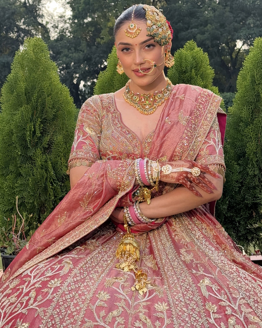Gulrang pink tissue bridal lehenga seated, embroidered blouse and skirt detail, Amaltas Couture