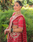 Meera red Banarasi bandhej saree side view, embroidered blouse sleeves, Amaltas Couture