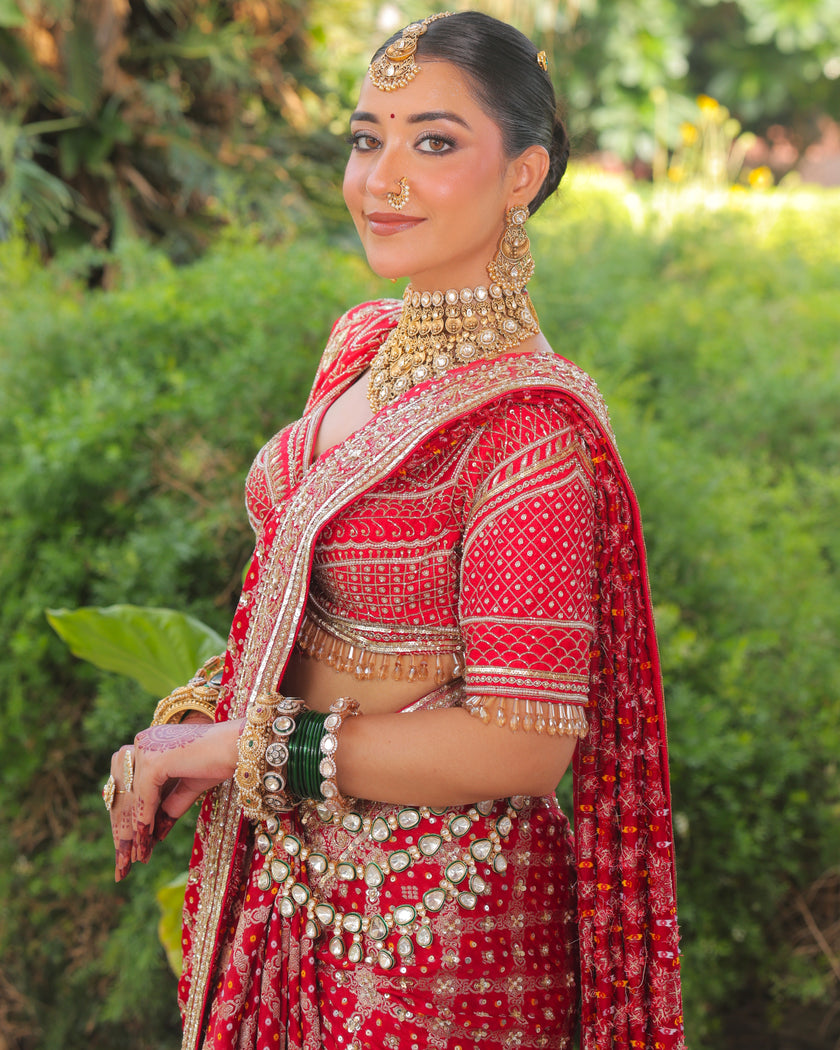 Meera red Banarasi bandhej saree side view, embroidered blouse sleeves, Amaltas Couture